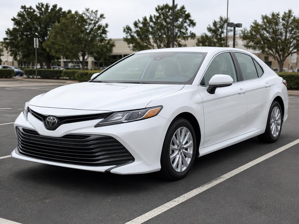 White Toyota Camry sedan available for weekly rental